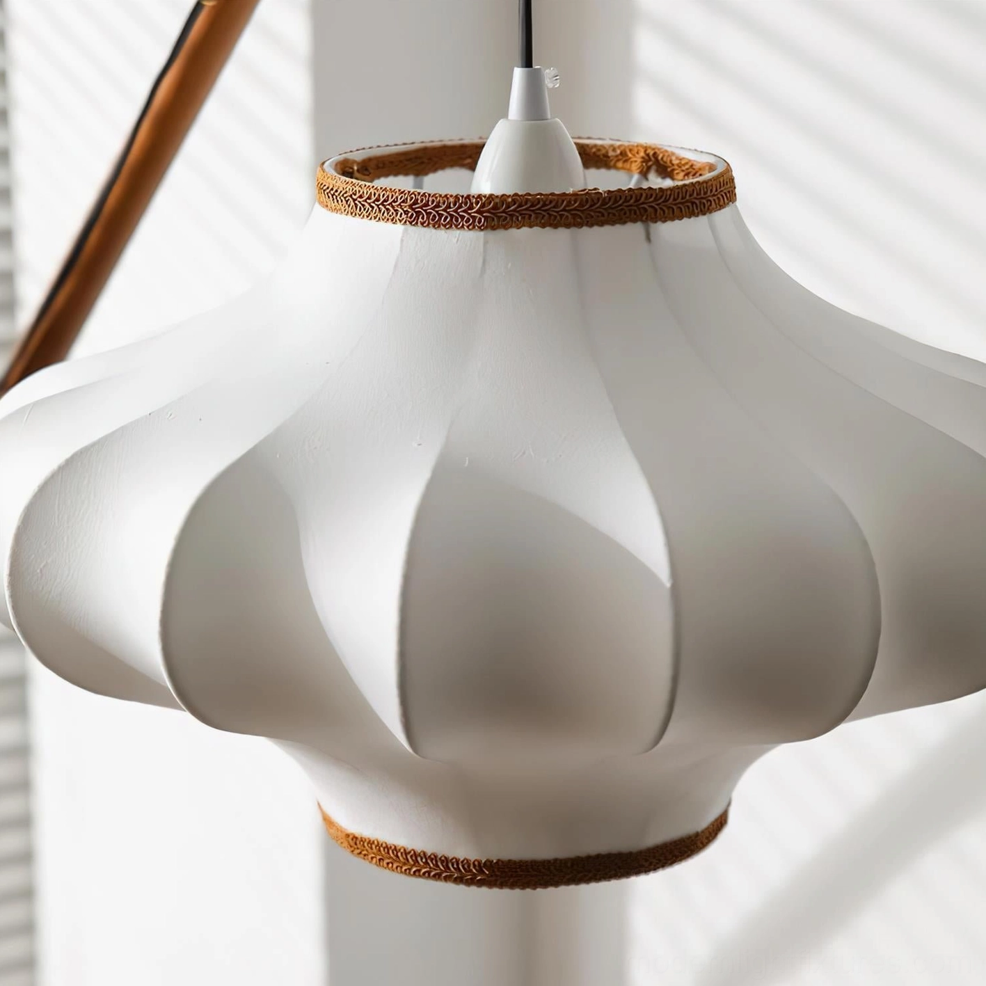 Designer arc floor lamp featuring angled arm, pleated fabric shade, and premium wood and brass construction