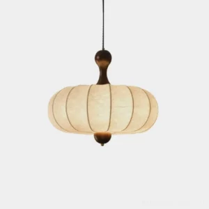 Hinora gored silk pendant light with oval fabric lantern shade and dark turned finials, studio view