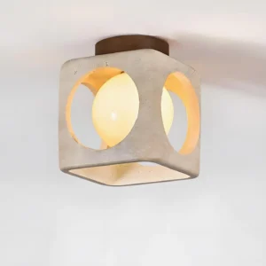 Hollowa modern ceiling lamp three-quarter angle showing lit glass orb interior and stone cutouts
