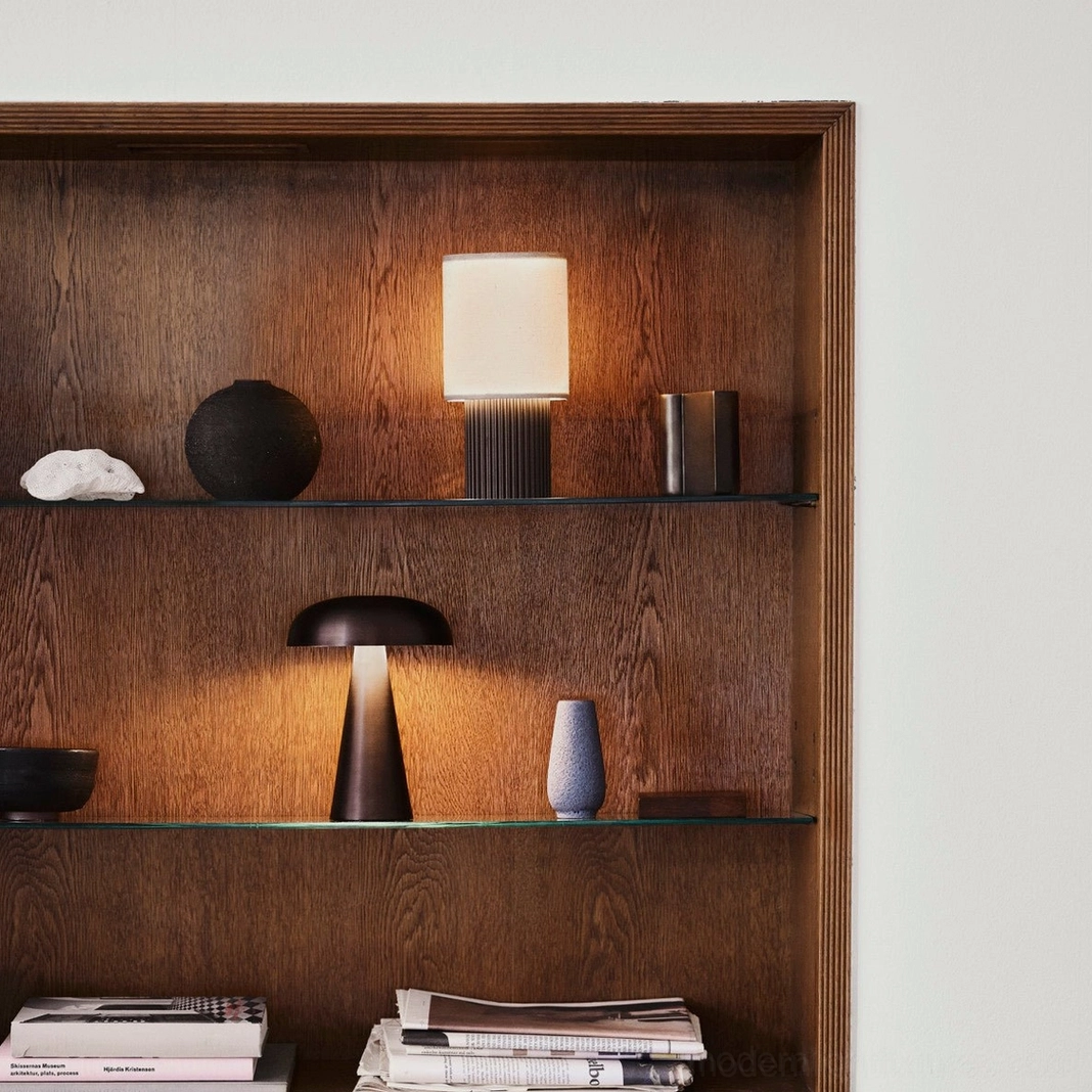 Warm white table lamp illuminating home office workspace, contemporary design complementing modern industrial and Scandinavian interior styles