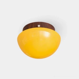 Honeyed Dome flush mount ceiling light with amber glass dome shade and wood grain metal canopy in warm white light