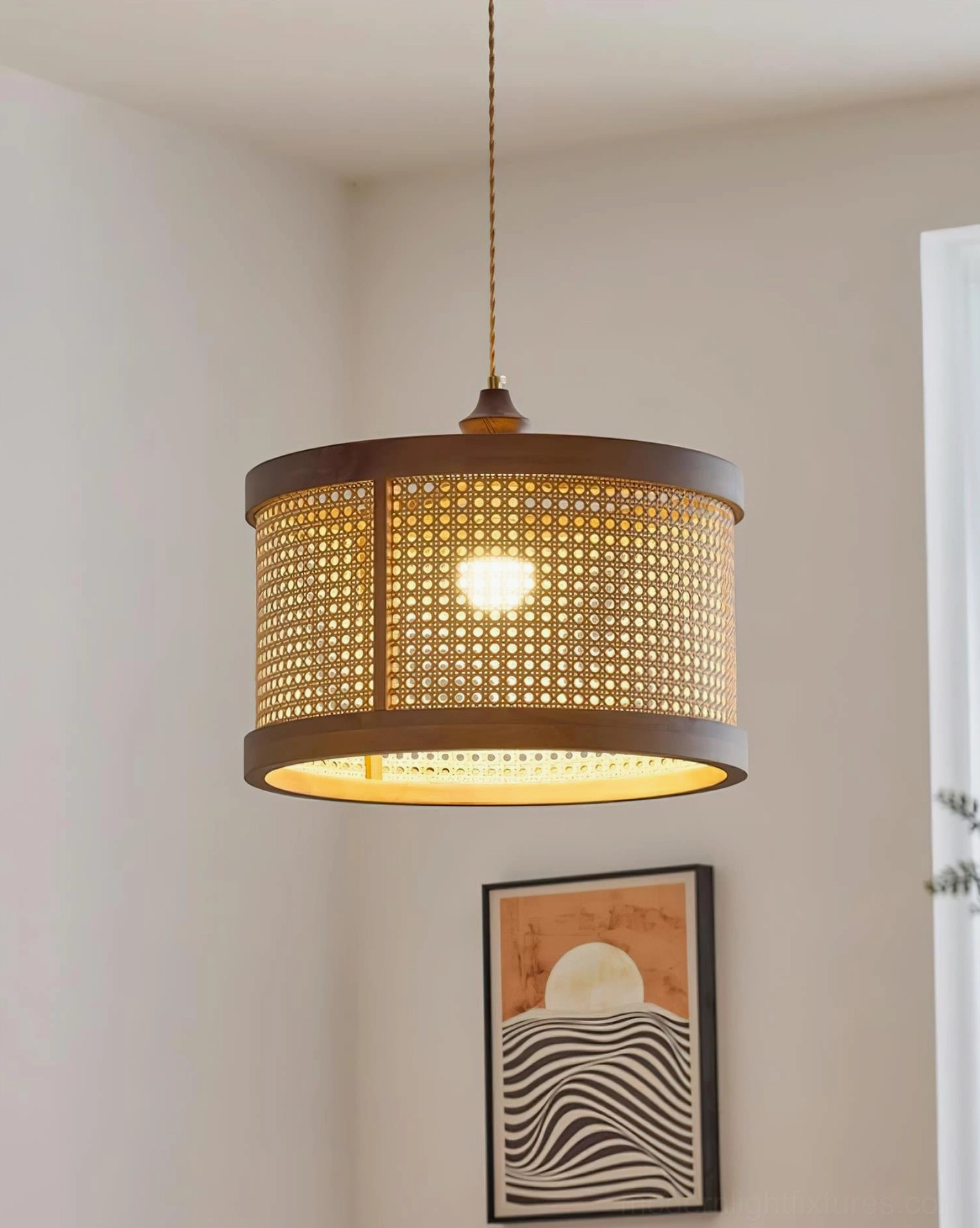 Hoopa cylindrical rattan pendant lamp installed in modern living room with artistic wall decor
