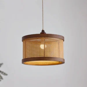 Illuminated Hoopa rattan pendant lamp casting warm light through woven shade texture