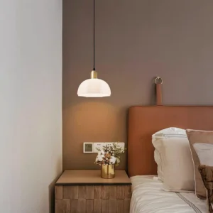 Scalloped horn pendant lamp in bedroom bedside setting with warm ambient lighting