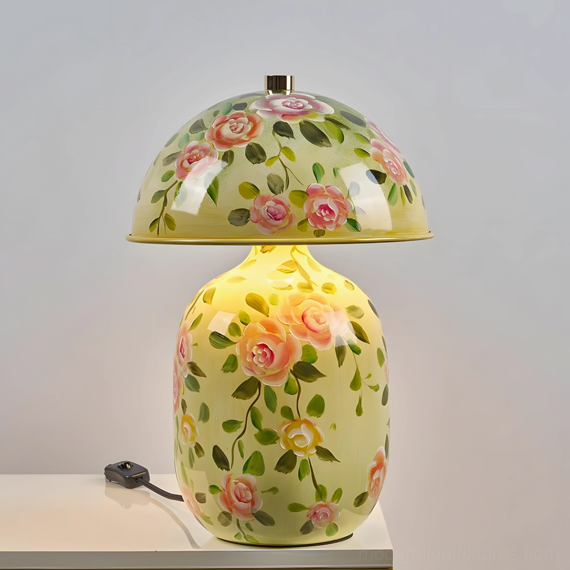 Illuminated warm LED table lamp with soft yellow hand-painted ceramic shade in bedroom setting