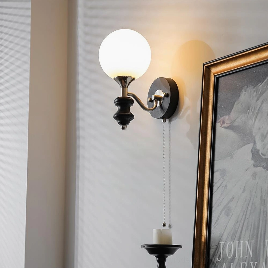 Illuminated spherical wall sconce casting warm ambient light in hallway interior design