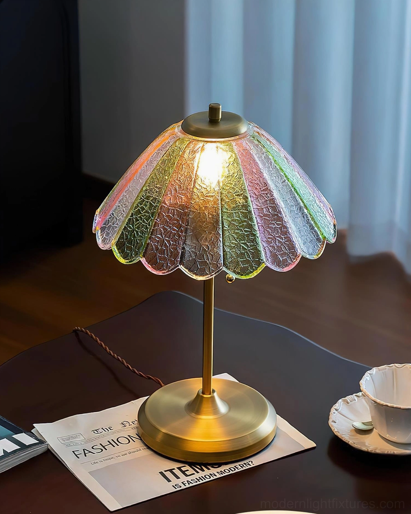 Illuminated vintage glass table lamp with brass pull chain switch creating warm dappled light