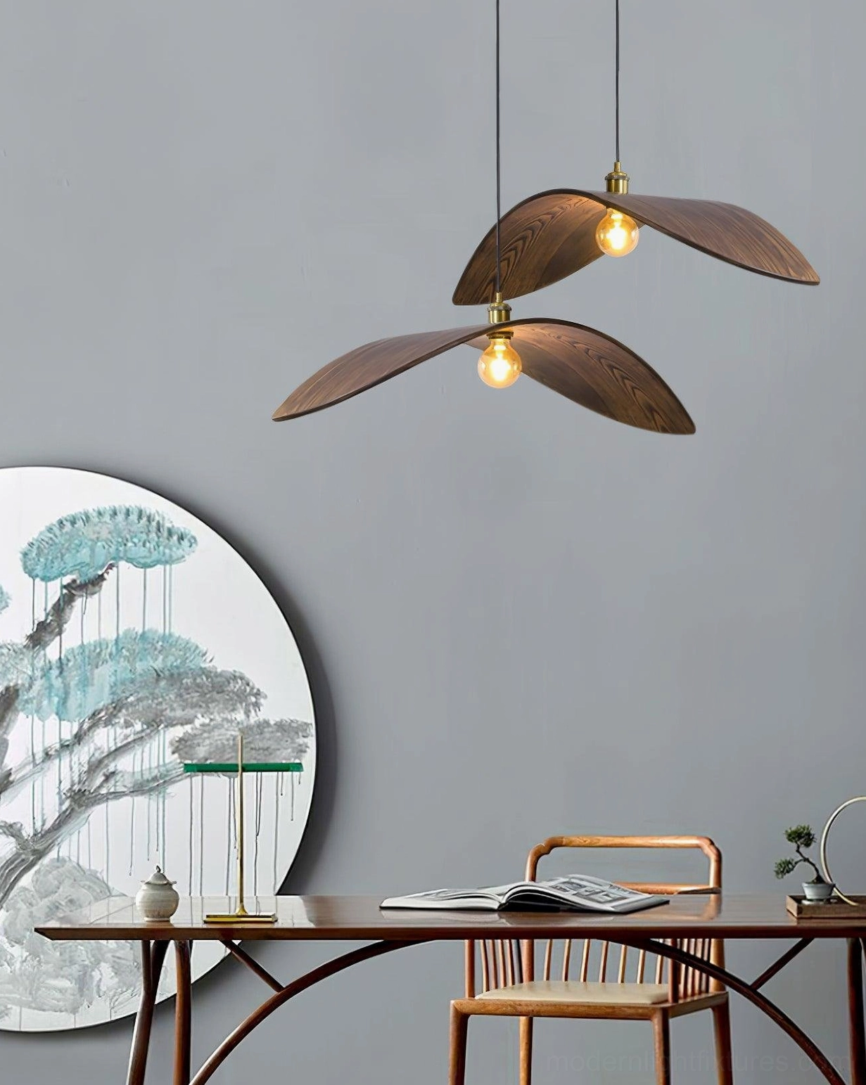 Full view of walnut wood leaf pendant lamp illuminated in residential living space showing light diffusion