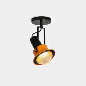 Triton Focus industrial adjustable ceiling spotlight with black metal arm and orange PMMA shade, front overhead view