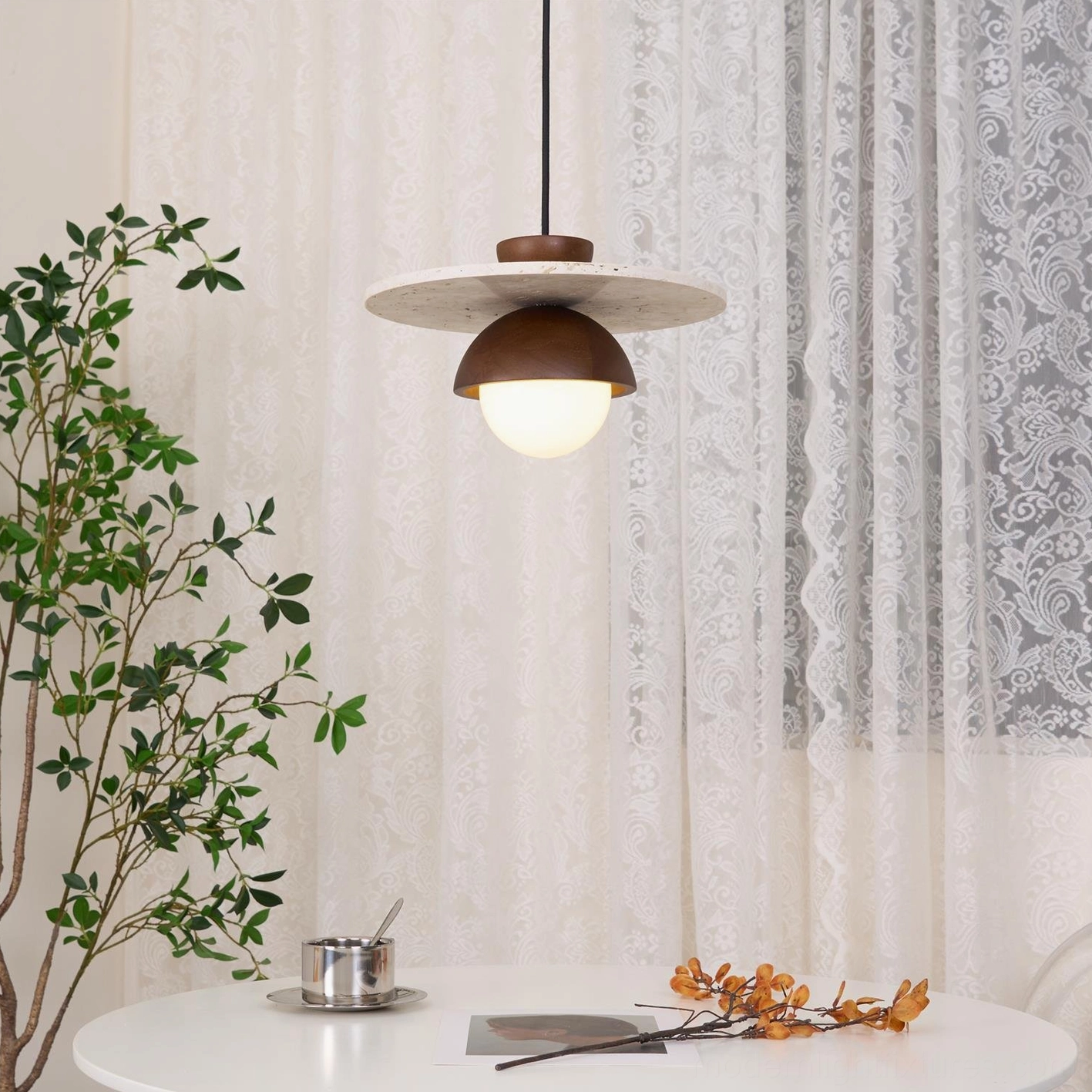 Industrial chic ceiling pendant with organic travertine canopy and modern glass sphere