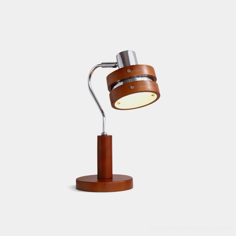 Industrial modern table lamp with adjustable chrome arm and walnut wood barrel shade, front three-quarter studio view