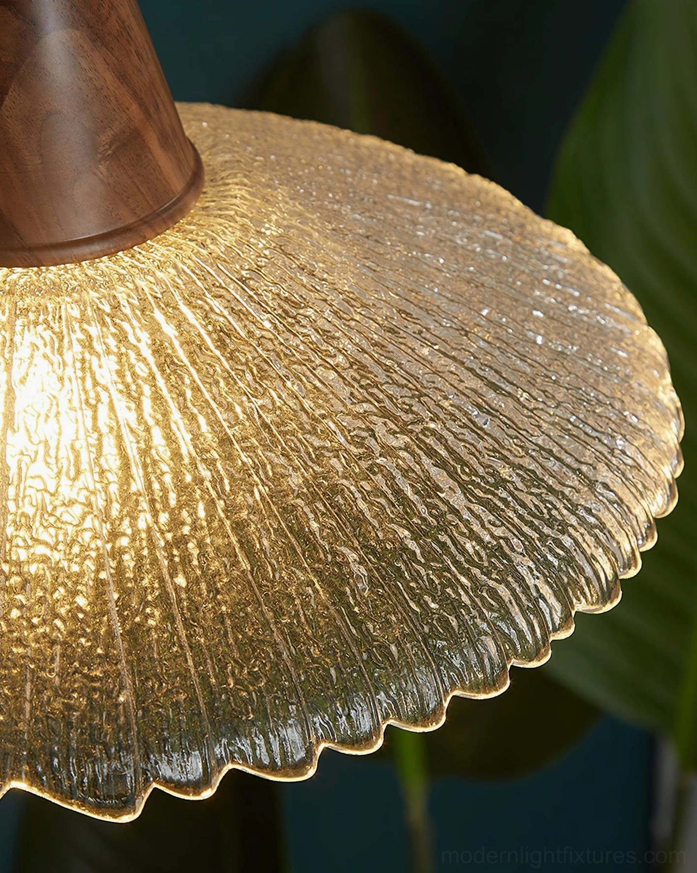 Industrial-modern walnut pendant light with brass hardware and textured glass in residential space