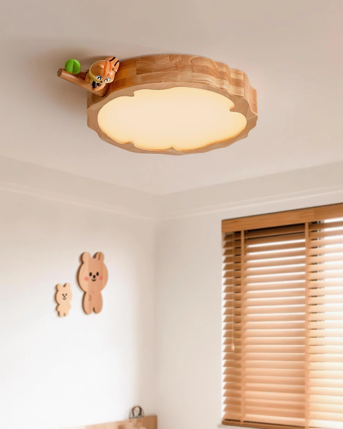 Animal ceiling light fixture installed in modern kids bedroom with soft warm illumination and nature wall decals