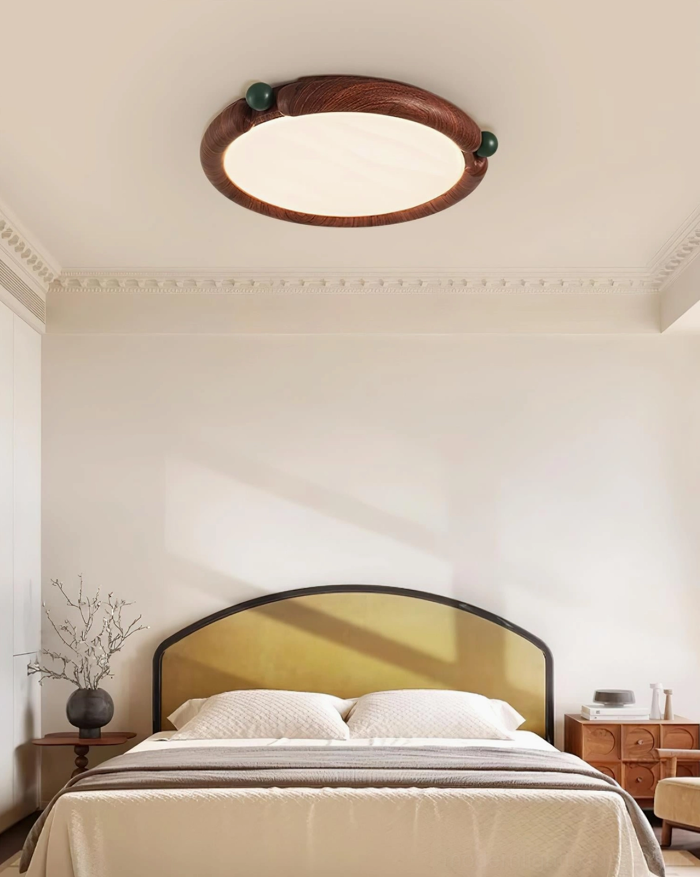 Installed modern round ceiling light in vintage bedroom, warm ambient lighting on decorative headboard