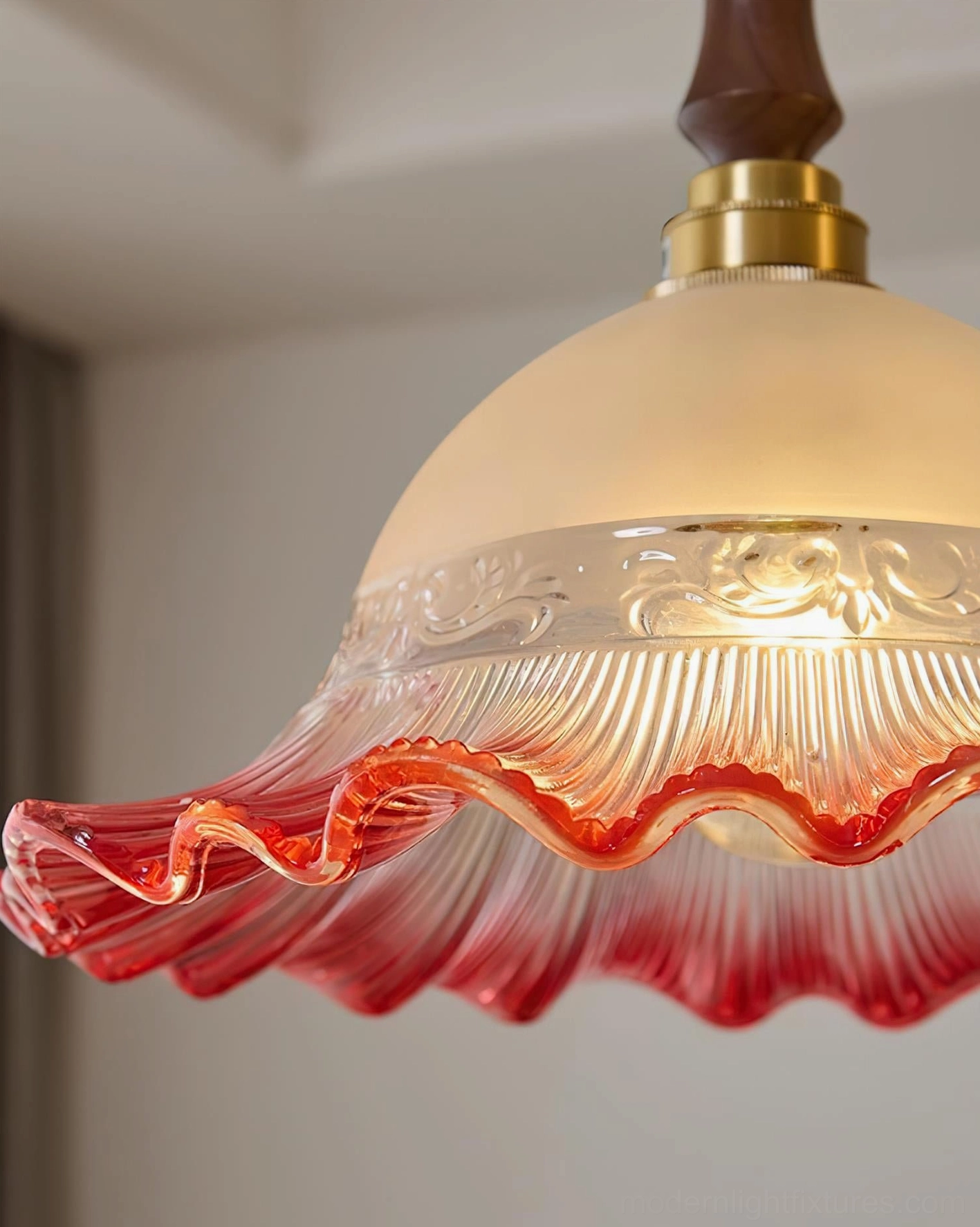 Frosted glass hand-blown pendant with intricate embossed detailing and brass accents