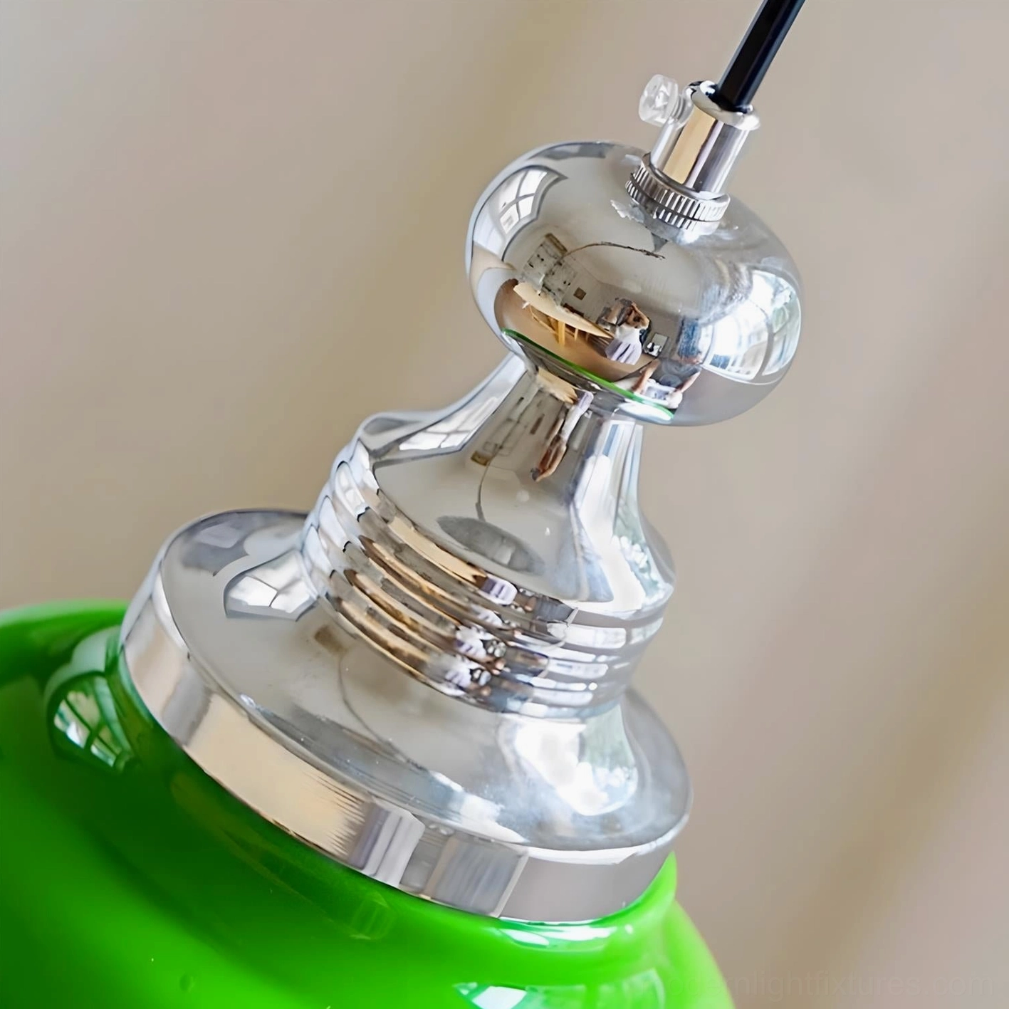 Modern jade green pendant light illuminated creating warm ambient glow in contemporary home