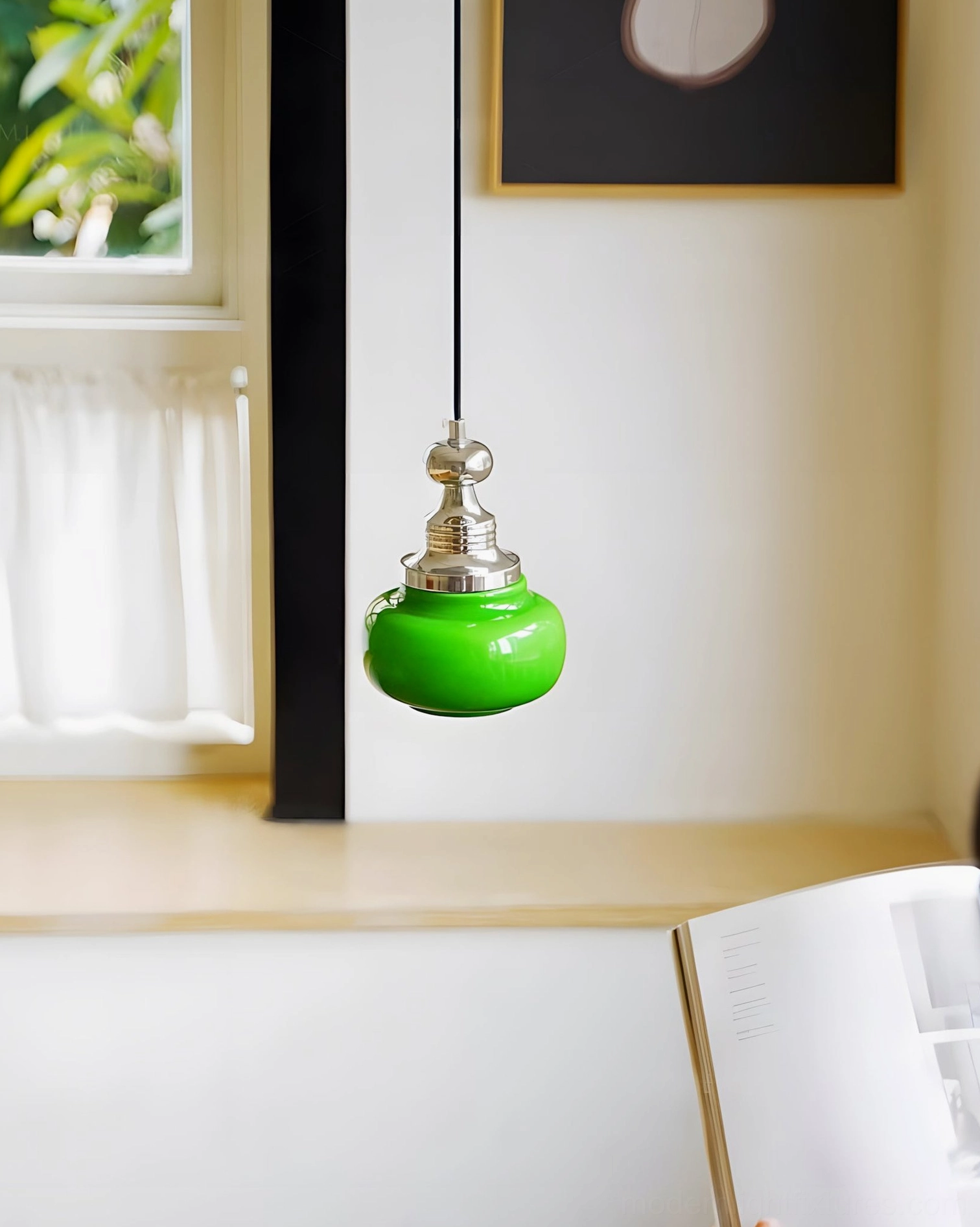 Modern jade green pendant light installed above wooden kitchen counter window display