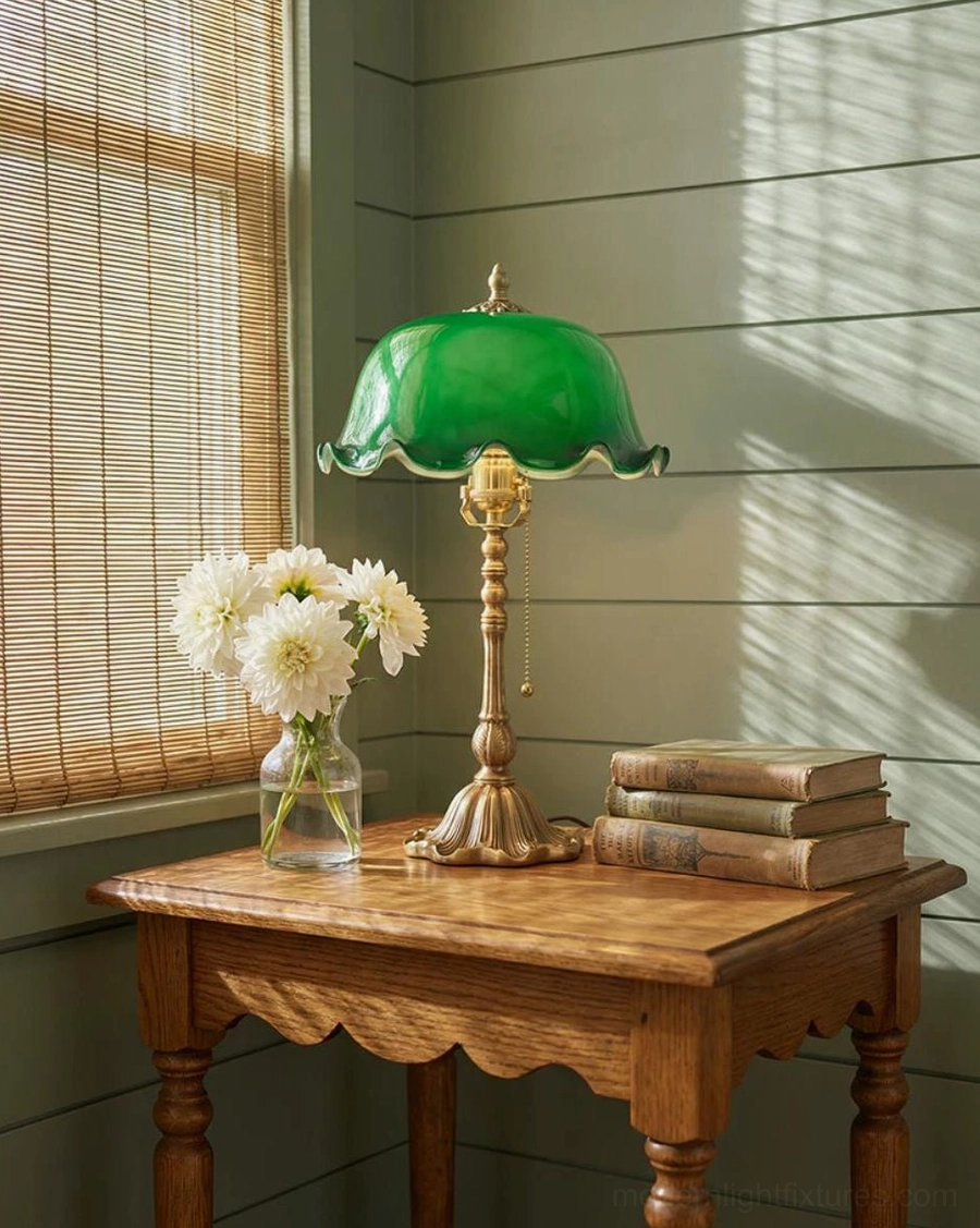 Jadelle table lamp displayed on carved wooden side table with white flowers and stacked books near window