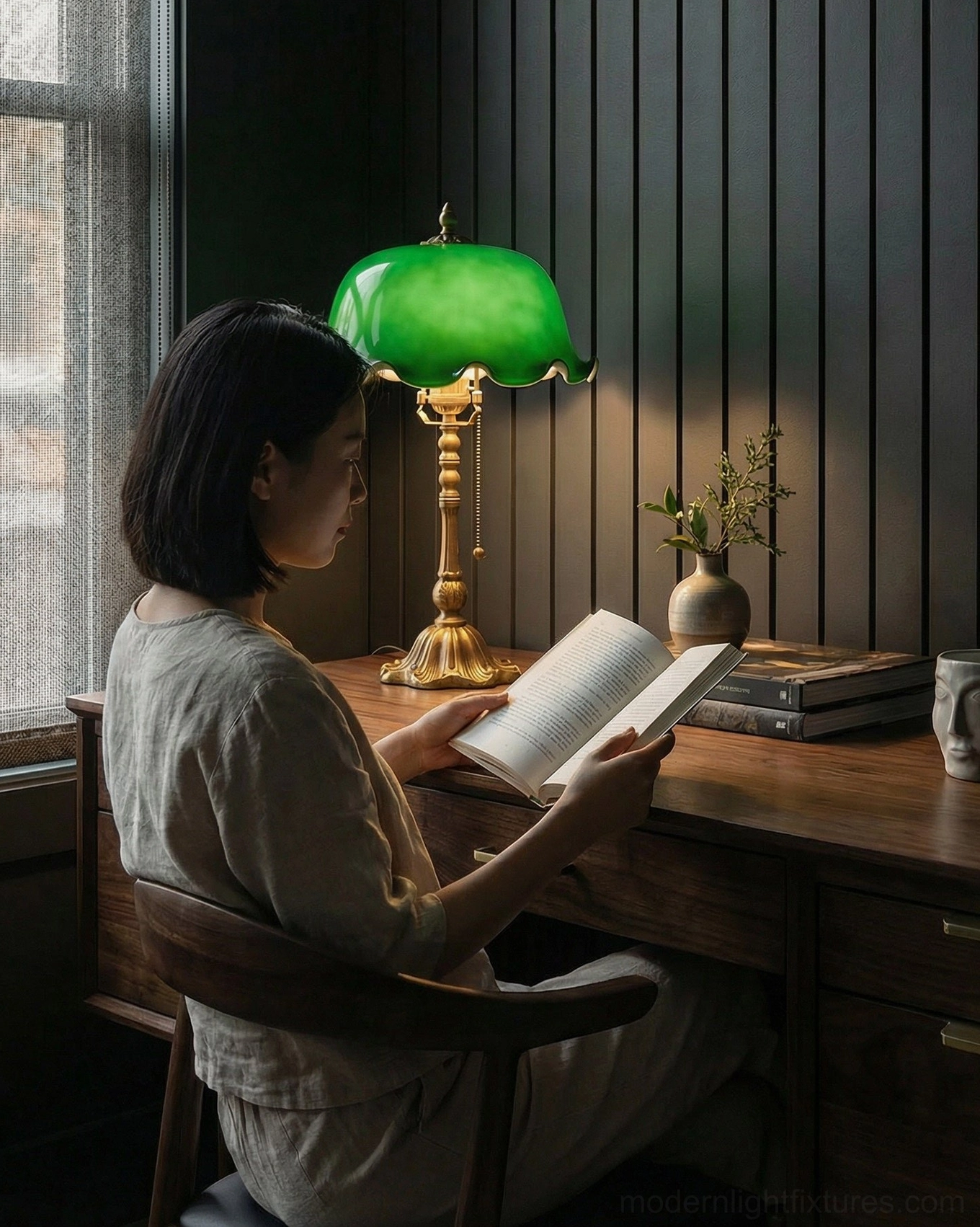 Jadelle table lamp in home office reading space on wooden desk with person reading