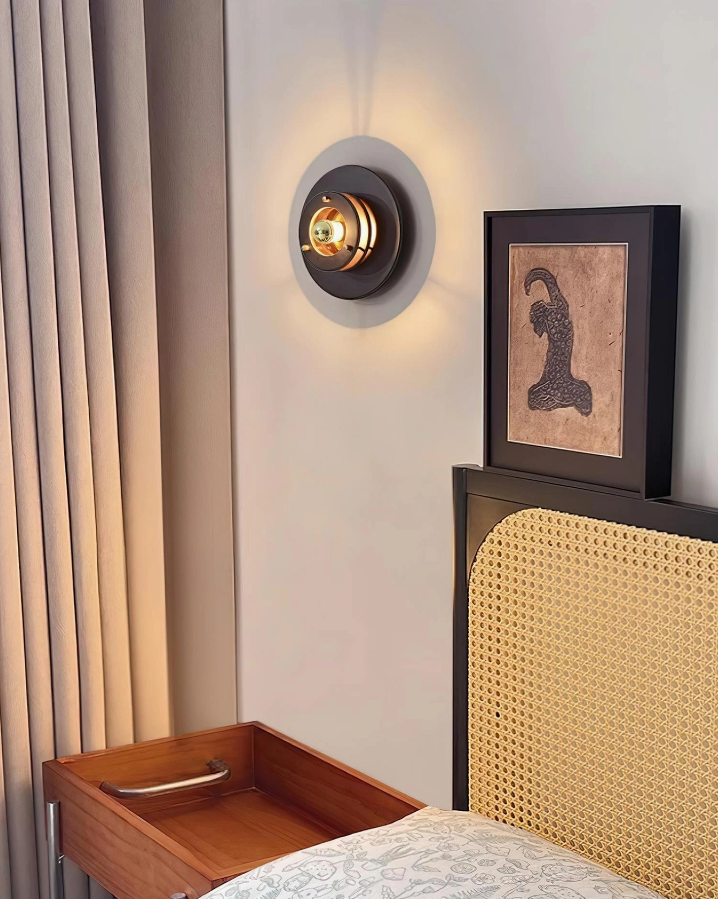 Jaima wall sconce in compact master bedroom eye-level view complementing wooden bedside table and framed wall art