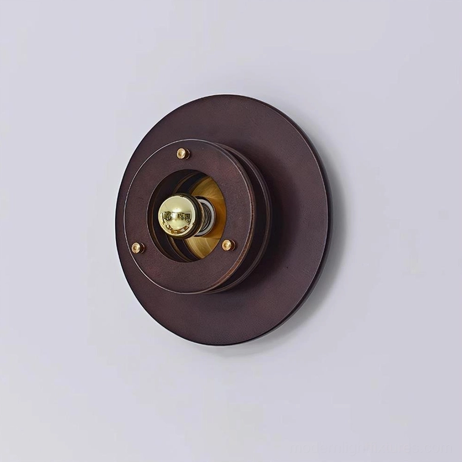 Jaima wall sconce gold and walnut color variant mounted in modern interior creating focal point accent lighting