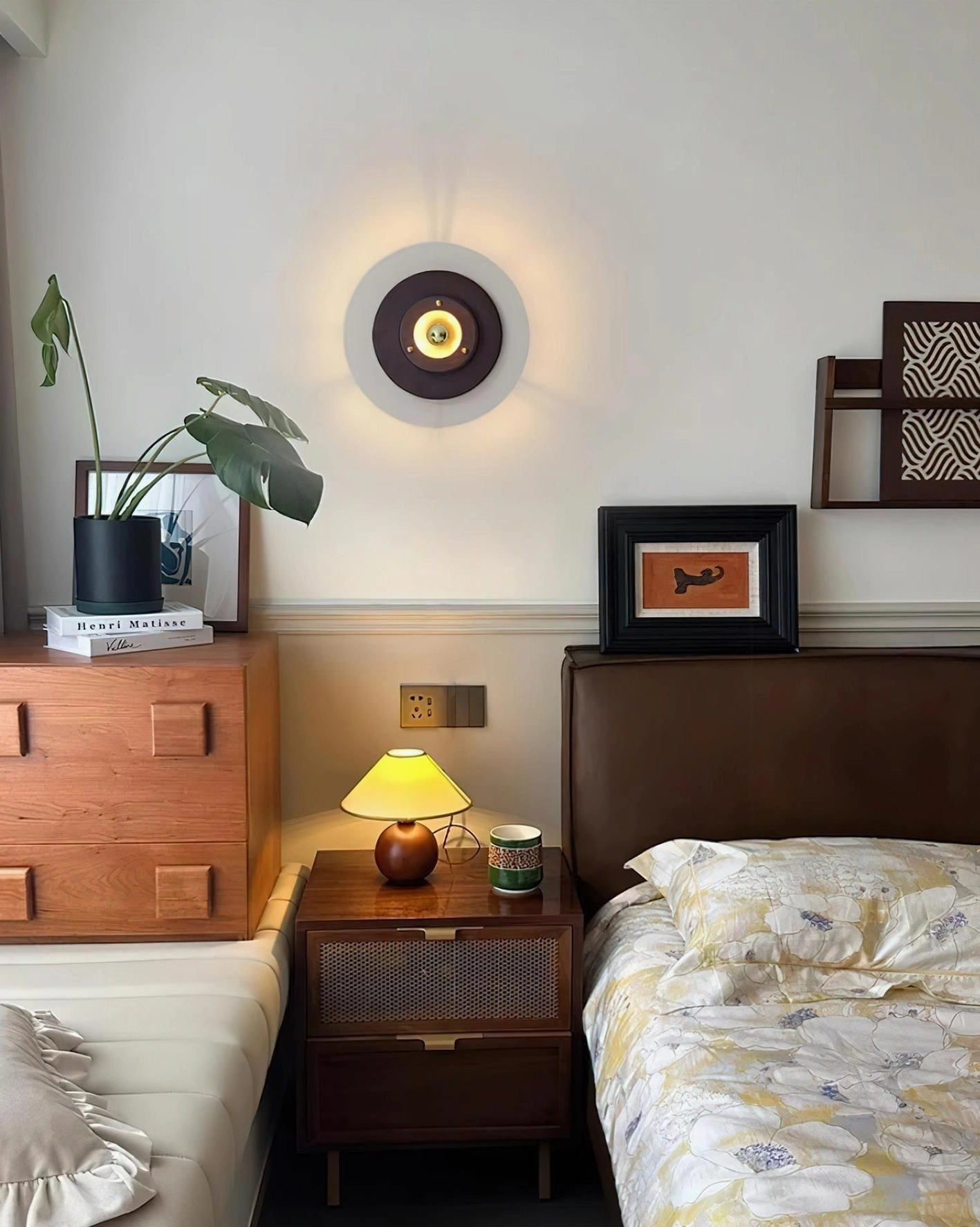 Jaima wall sconce mounted in cozy twin bedroom with retro decor and wooden furniture creating intimate reading light