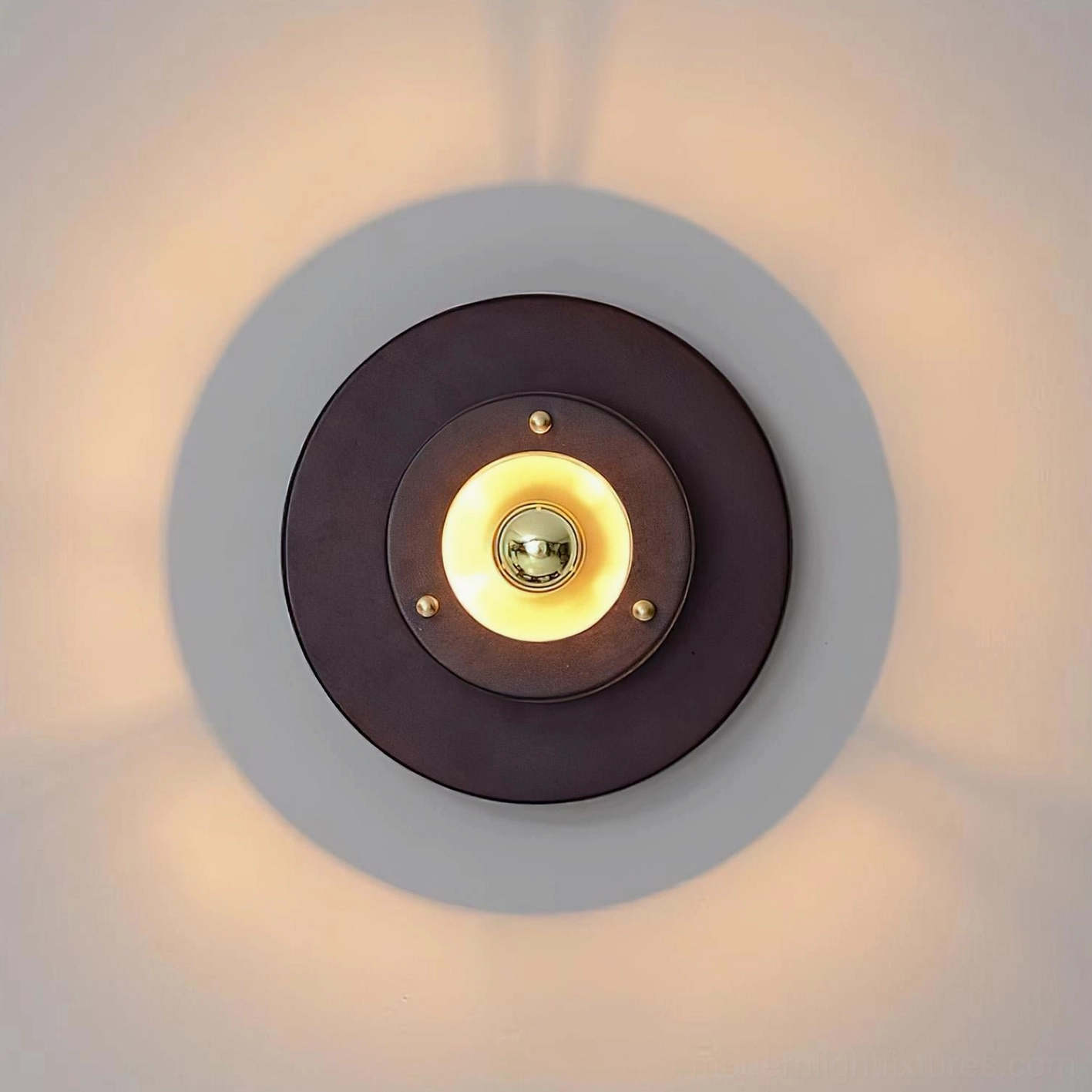 Jaima round wall lamp illuminated with warm glow showcasing annular ring lighting effect from exposed bulb design