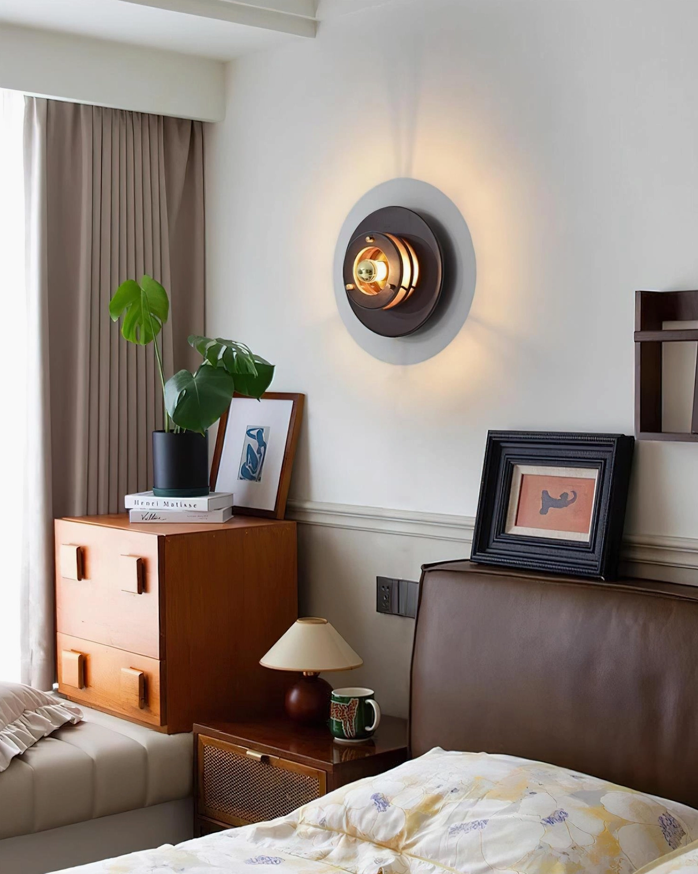 Jaima wall sconce installed above bedside nightstand in modern American master bedroom creating warm ambient lighting