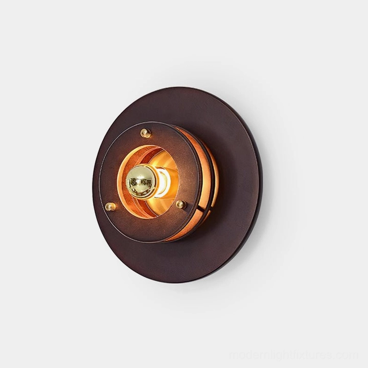 Jaima round wall sconce close-up front view showing layered circular disc design with dark walnut wood and brass metal details