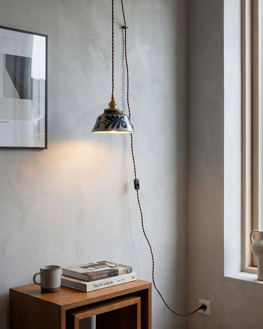 Japandi plug-in pendant light with indigo hand-glazed ceramic shade installed in minimalist residential corner nook, eye-level view