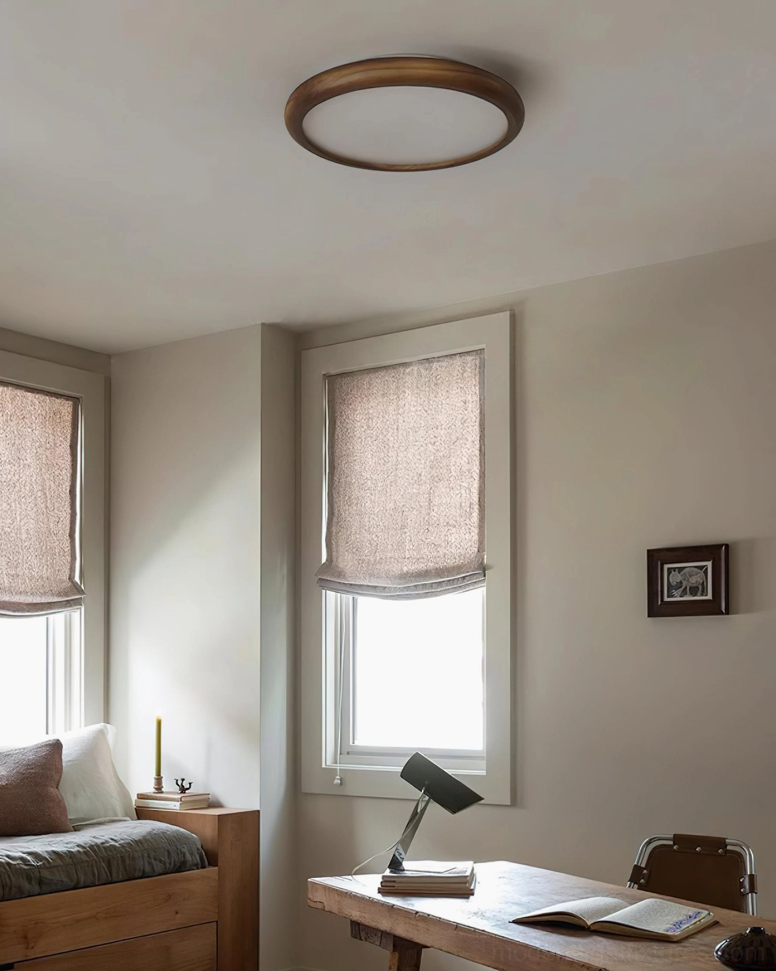 Compact flush mount ceiling light in minimalist japandi-style bedroom with dark wood frame and soft warm glow