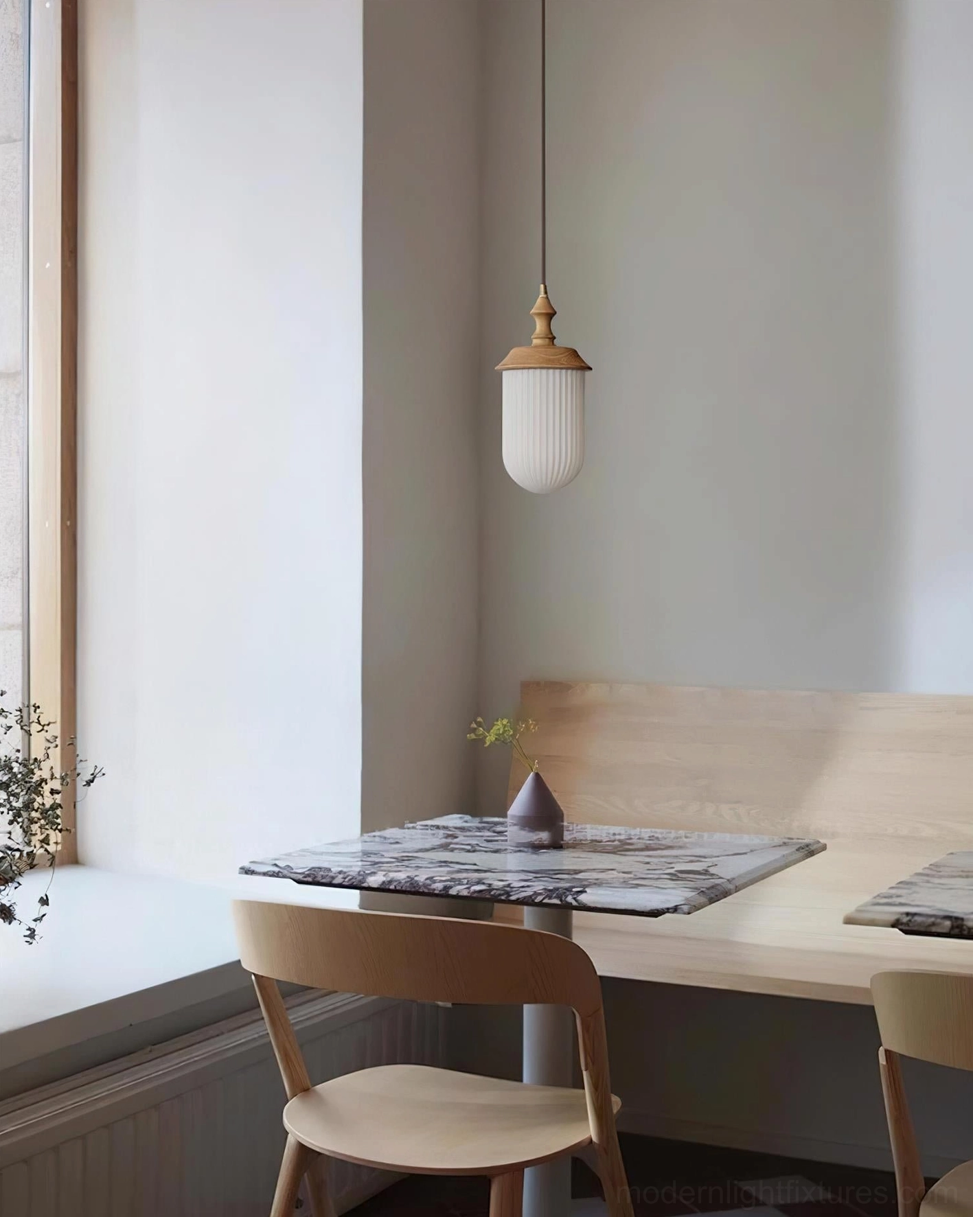 Japandi pendant lamp in dining nook with natural window light and wooden dining setup