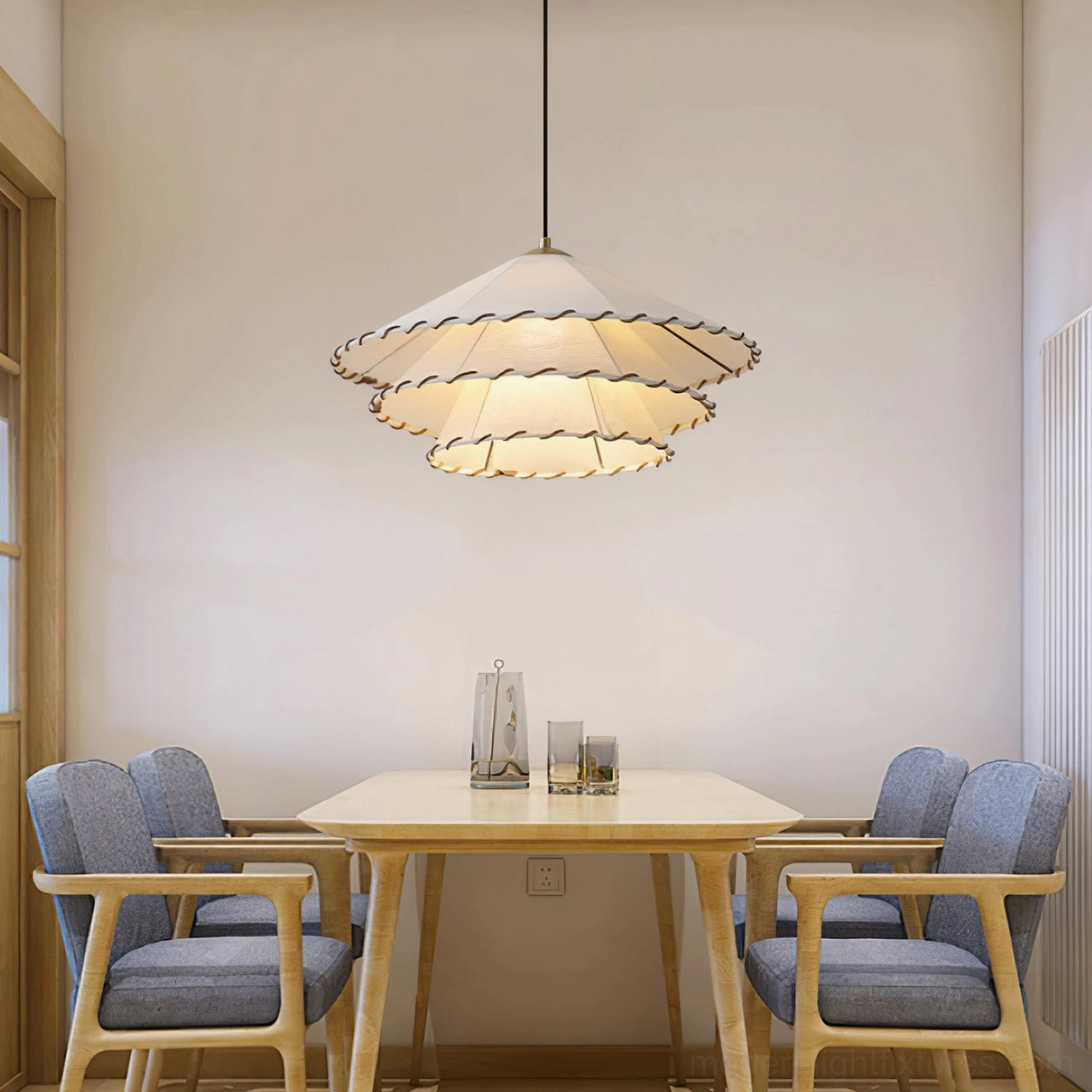 Double-layer fabric pendant light in minimalist dining space with blue upholstered chairs and japandi styling