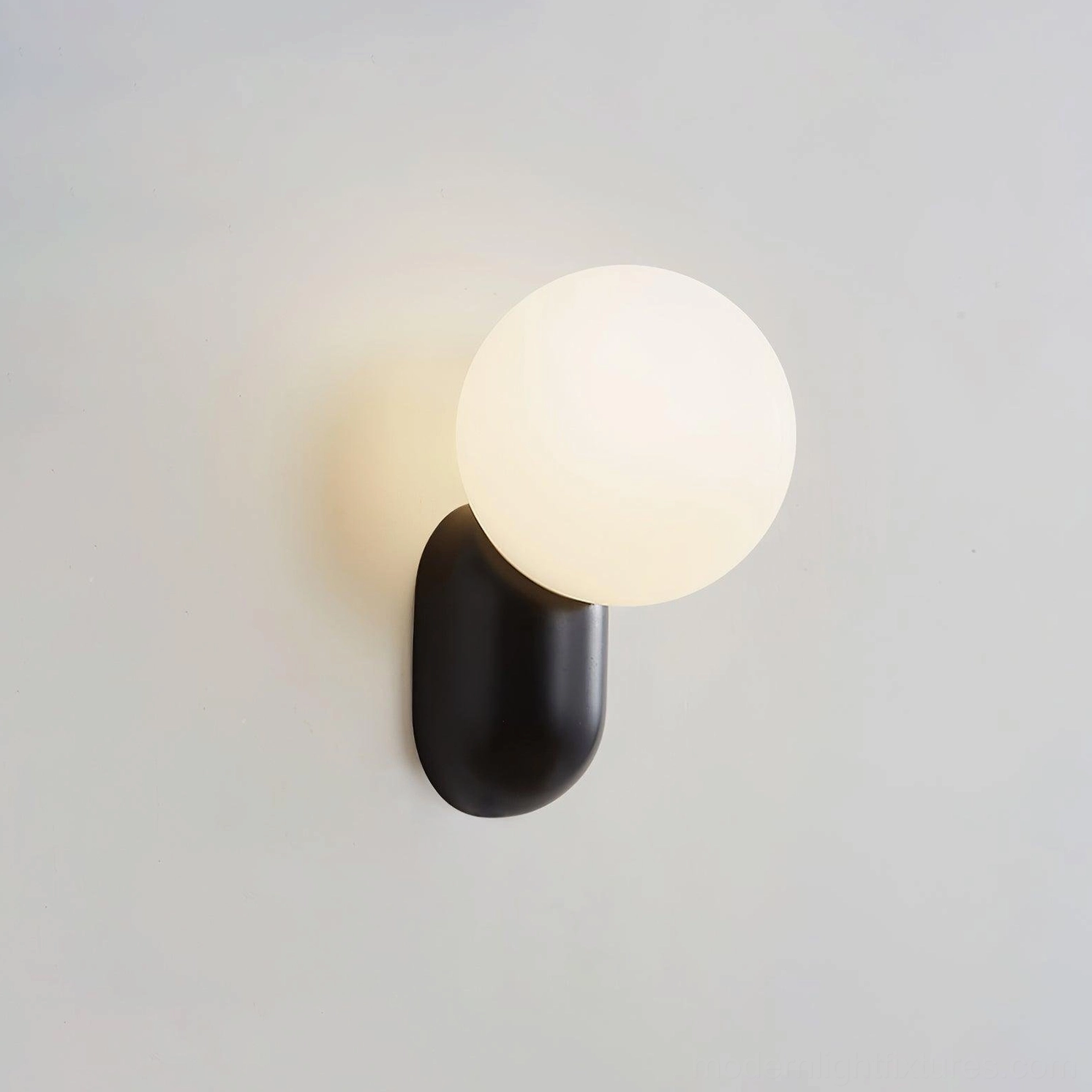 Japandi fusion interior featuring spherical wall sconce emphasizing simplicity and geometric harmony