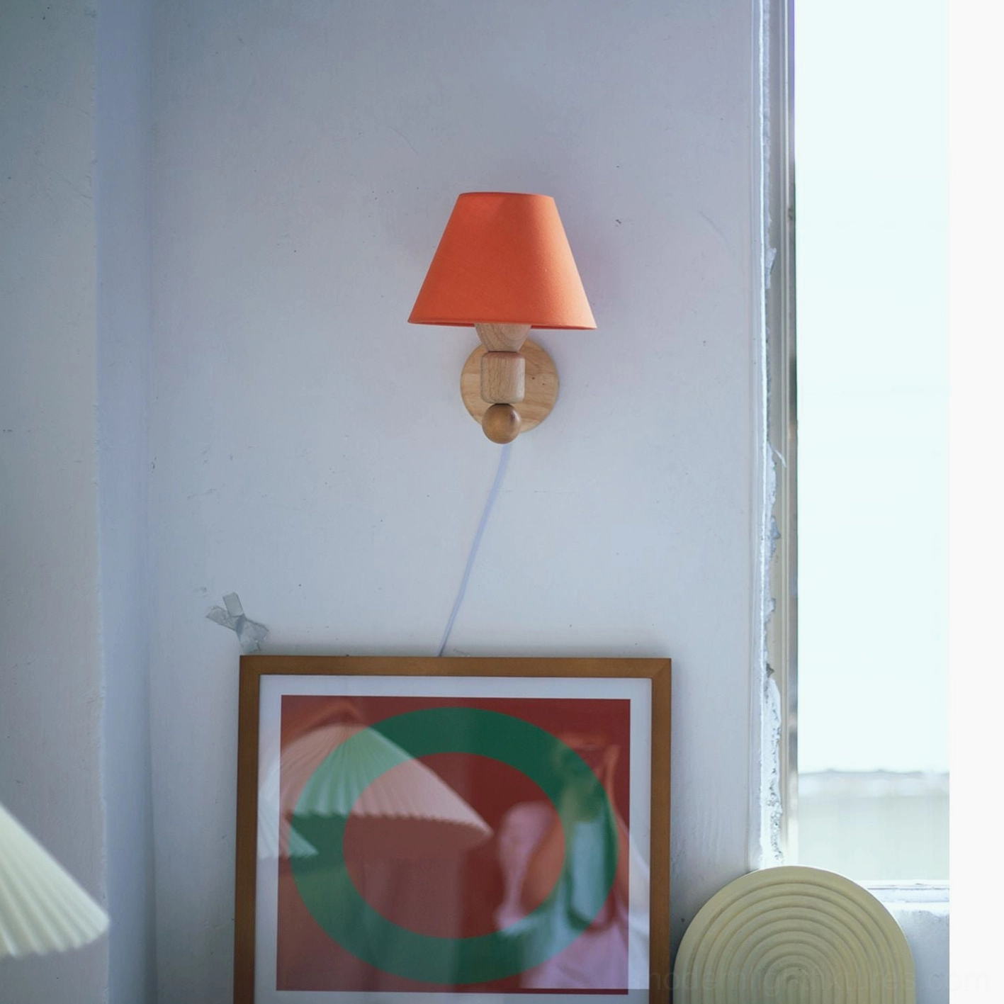 Japandi wall sconce with natural wood grain and warm cream shade demonstrating minimalist hardwired lighting design