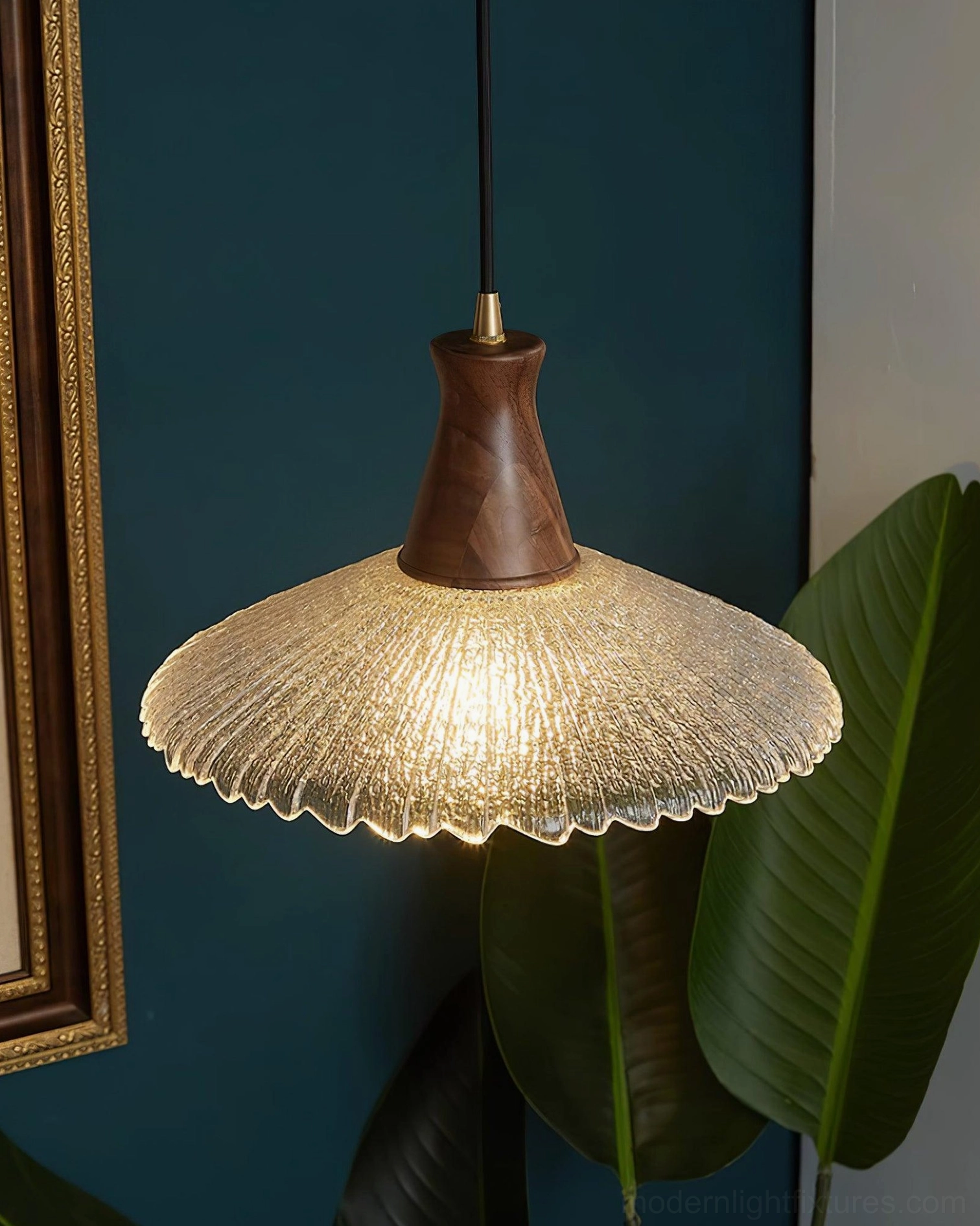 Japandi pendant light fixture with natural wood finish suspended above dining surface with warm lighting