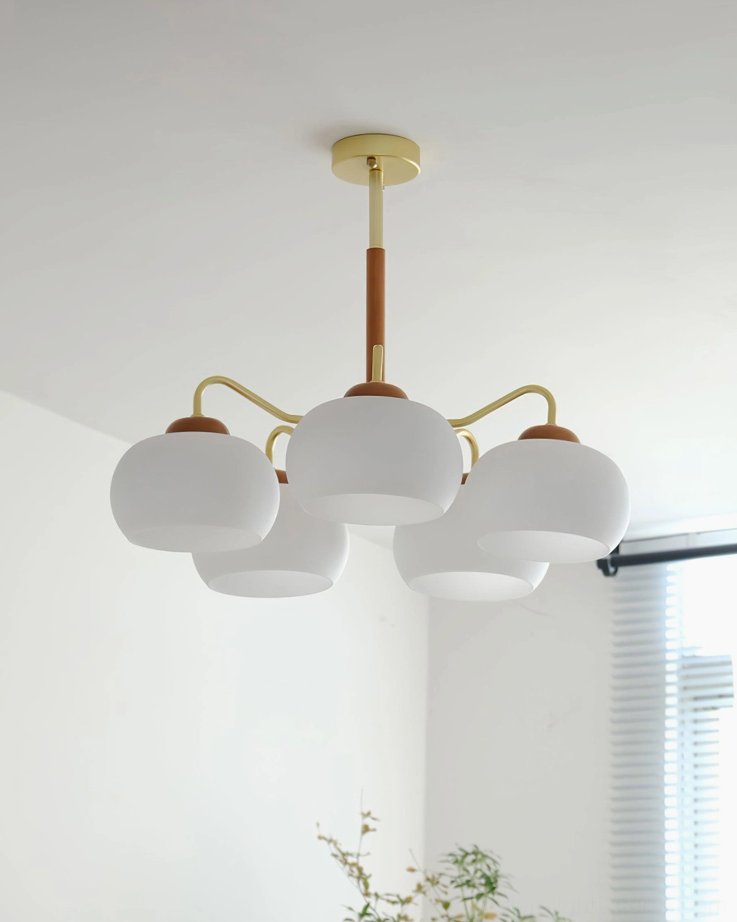 Japandi Nordic brass and wood pendant light fixture with frosted glass in minimalist interior with window blinds