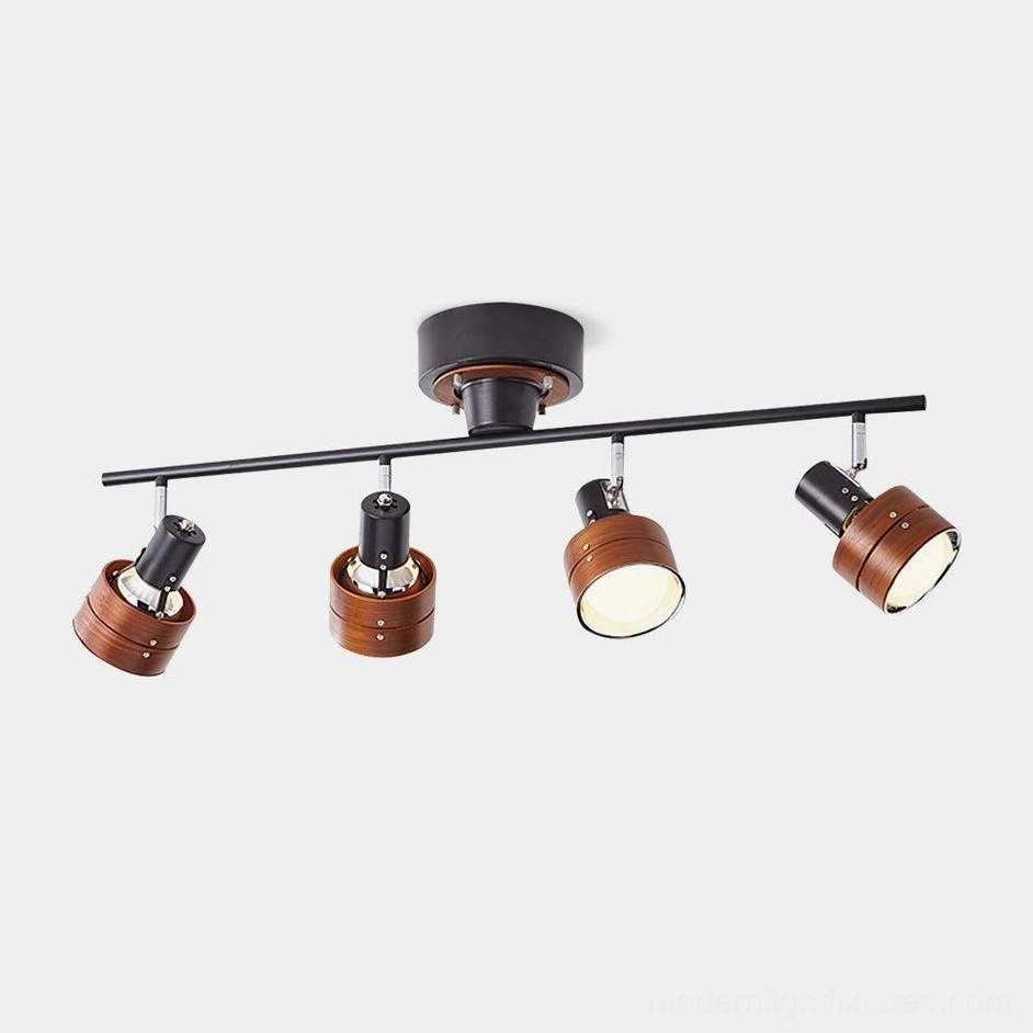 Japanese-inspired 4-head track lighting with black metal frame and walnut wood lamp housings on white background