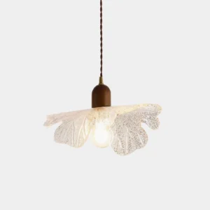Japanese-inspired petal glass pendant light with textured clear shade and warm bulb, front studio view
