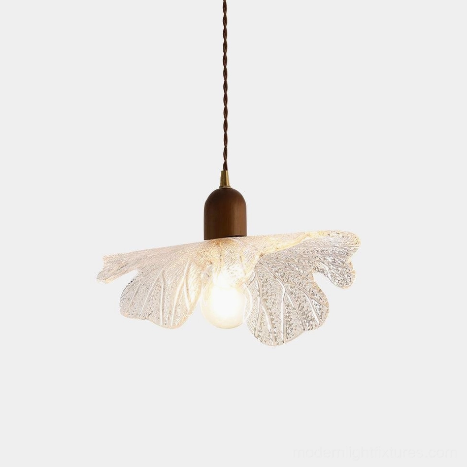Japanese-inspired petal glass pendant light with textured clear shade and warm bulb, front studio view