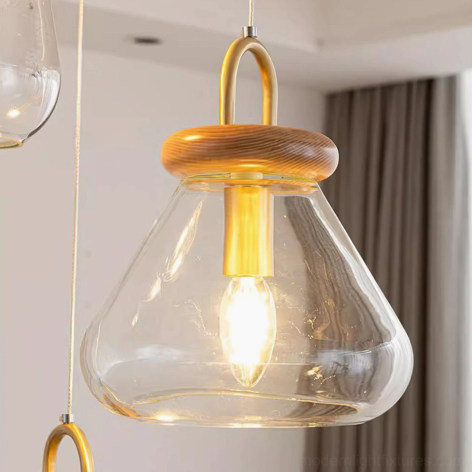 Close-up detail of jar pendant brass hardware, wood elements, and clear glass construction