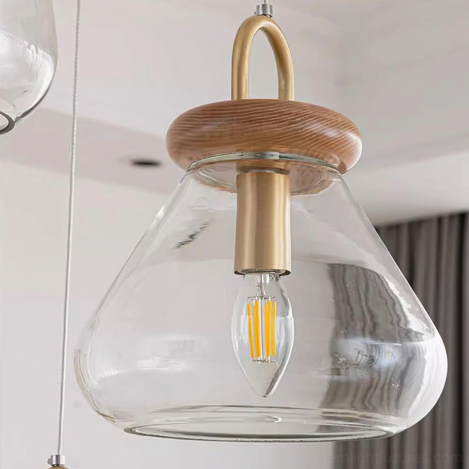 Jar pendant light showing bulb visibility through clear glass shade with warm illumination