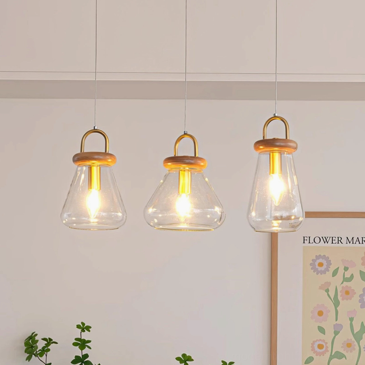Jar pendant lights in contemporary kitchen showing brass finish and wood accents in natural setting