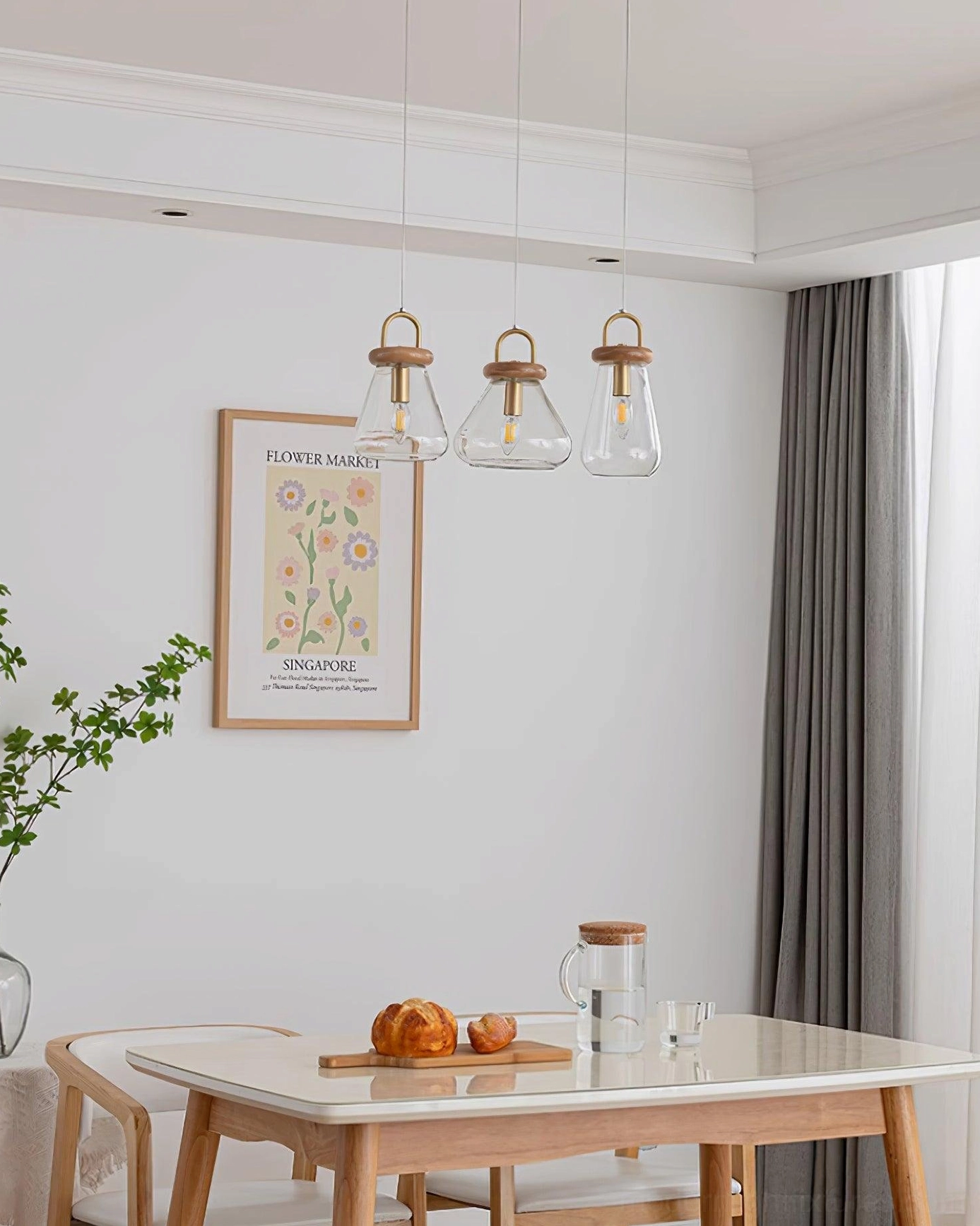 Multiple jar pendants lighting modern dining space from alternate angle showing interior design placement