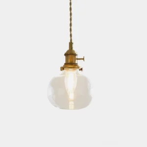 Jasmine glass pendant light with clear dome shade and brass fixture, studio frontal view