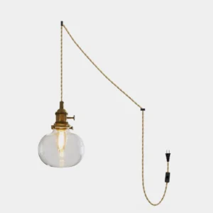 Jasmine clear glass plug-in pendant light with brass socket and braided cord – studio product photography