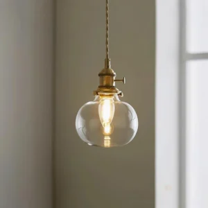 Jasmine globe glass pendant light with spherical shade and brass hardware, close-up frontal view