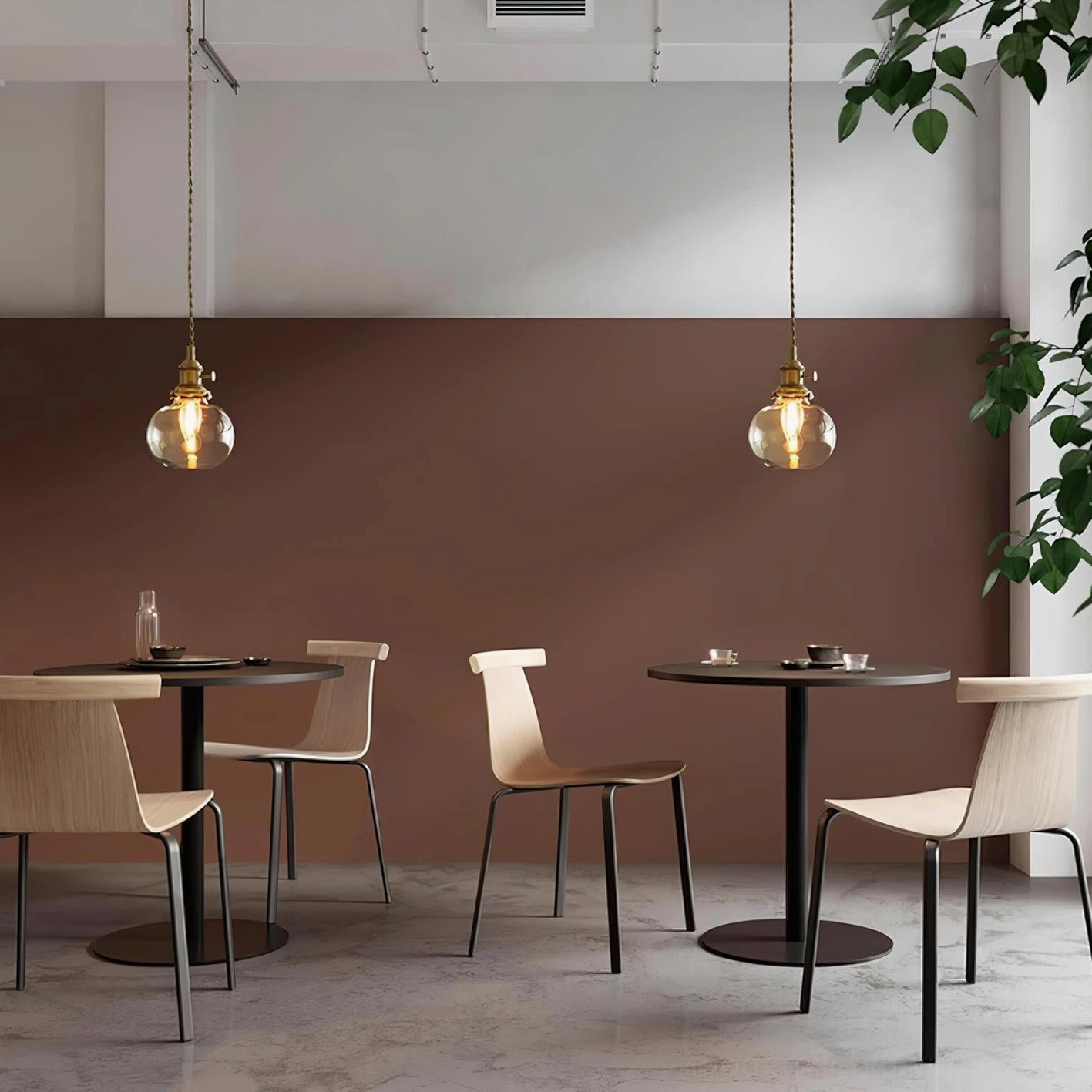 Two Jasmine globe glass pendant lights creating warm ambient lighting in small cafe dining area