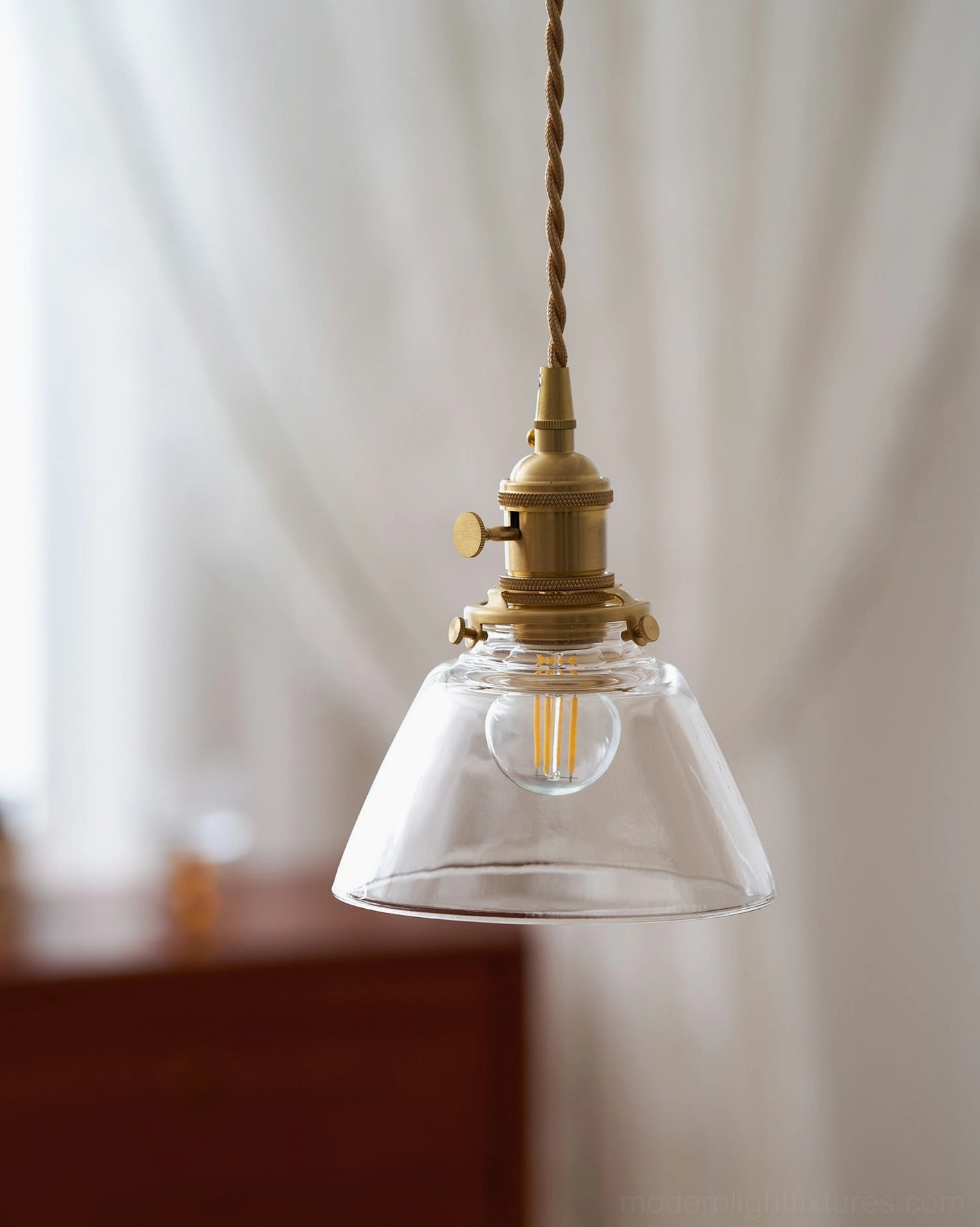 Three Jasmine glass pendants mixed models creating curated lighting arrangement with unified brass design