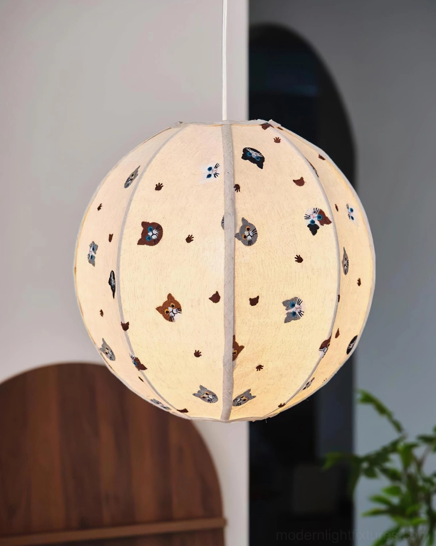 Jayne fabric pendant lamp glowing warmly in wooden home décor space with plants and natural elements